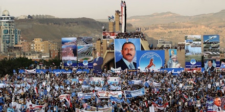 TOPSHOT - Hundreds of thousands of Yemenis hold posters and portraits of Yemen's ex-president Ali Abdullah Saleh during a demonstration in support of the former president, as his political party marks 35 years since its founding, at Sabaeen Square in the capital Sanaa on August 24, 2017. The rally comes amid reports that armed supporters of Saleh and the head of the country's Huthi rebels, who have been allied against the Saudi-backed government since 2014, had spread throughout the capital as tensions are rising between the two sides. / AFP PHOTO / MOHAMMED HUWAIS (Photo credit should read MOHAMMED HUWAIS/AFP/Getty Images)