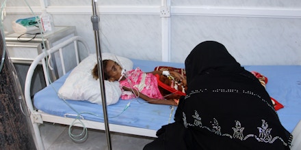 TOPSHOT - A Yemeni mother tends to her malnourished child as she receives treatment at a hospital in the Yemeni port city of Hodeidah, on May 2, 2017.  / AFP PHOTO / STR        (Photo credit should read STR/AFP/Getty Images)