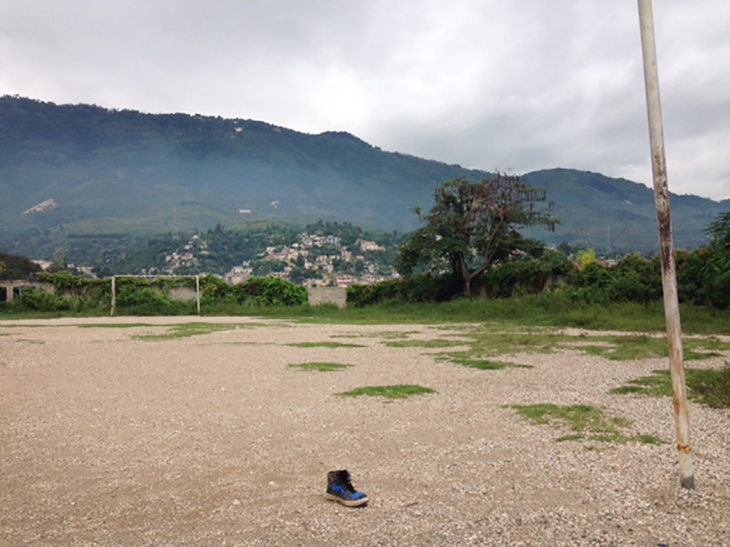 Four days after the raid a single shoe sits in the middle of the Soccer field behind Maranatha College in Port-au-Prince, on Nov. 17, 2017.