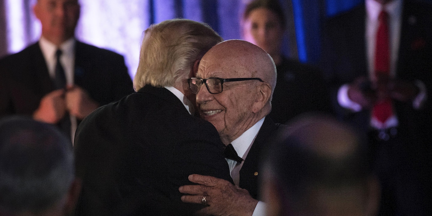 US President Donald Trump (L) is embraced by Rupert Murdoch, Executive Chairman of News Corp, during a dinner to commemorate the 75th anniversary of the Battle of the Coral Sea during WWII onboard the Intrepid Sea, Air and Space Museum May 4, 2017 in New York, New York. / AFP PHOTO / Brendan Smialowski        (Photo credit should read BRENDAN SMIALOWSKI/AFP/Getty Images)