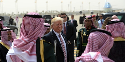 TOPSHOT - US President Donald Trump (C) makes his way to board Air Force One in Riyadh as he head with the First Lady to Israel on May 22, 2017. / AFP PHOTO / MANDEL NGAN        (Photo credit should read MANDEL NGAN/AFP/Getty Images)