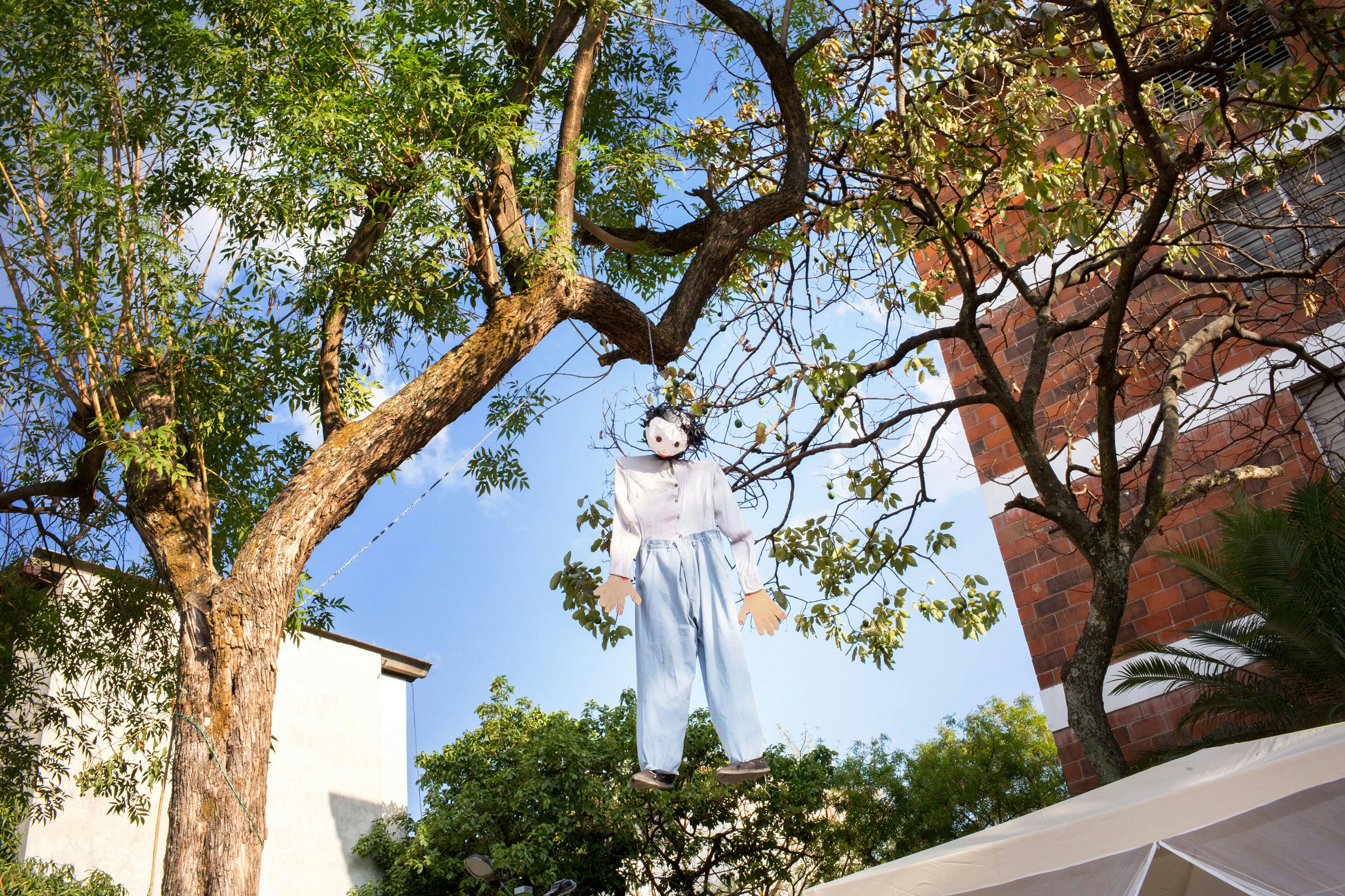 April 2017, El Salvador, San Salvador. An effigy of Judas hangs in the notoriously gang controlled neighborhood of Los Mejicanos, in Barrio 18 territory, the night before Easter Sunday. (Natalie Keyssar)