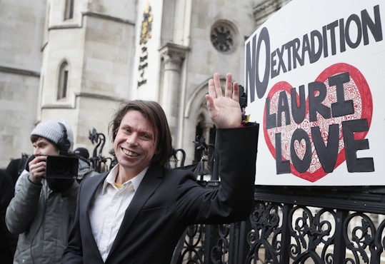 Lauri Love waves outside The Royal Courts of Justice in London, Monday, Feb. 5, 2018. The ruling in Lauri Love's appeal against extradition to the United States, where he faced solitary confinement and a potential 99 year prison sentence, was ruled in his favour on Monday Feb. 5 at the Royal Courts of Justice.(AP Photo/Kirsty Wigglesworth)
