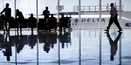 A Delta Air Lines jet sits at a gate at Hartsfield-Jackson Atlanta International Airport, in Atlanta, Thursday, Oct. 13, 2016. Lower airfares and rising salaries are putting a squeeze on Delta Air Lines. Luckily for the airline, the price of jet fuel remains cheap and the Atlanta-based carrier was able to report a third-quarter profit of $1.26 billion, down 4 percent from the same period a year earlier. (AP Photo/David Goldman)