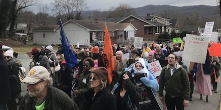 Protesters march through White Sulphur Springs, West Virginia to The Greenbrier resort, where the annual GOP congressional retreat is held on Feb. 1, 2018. 