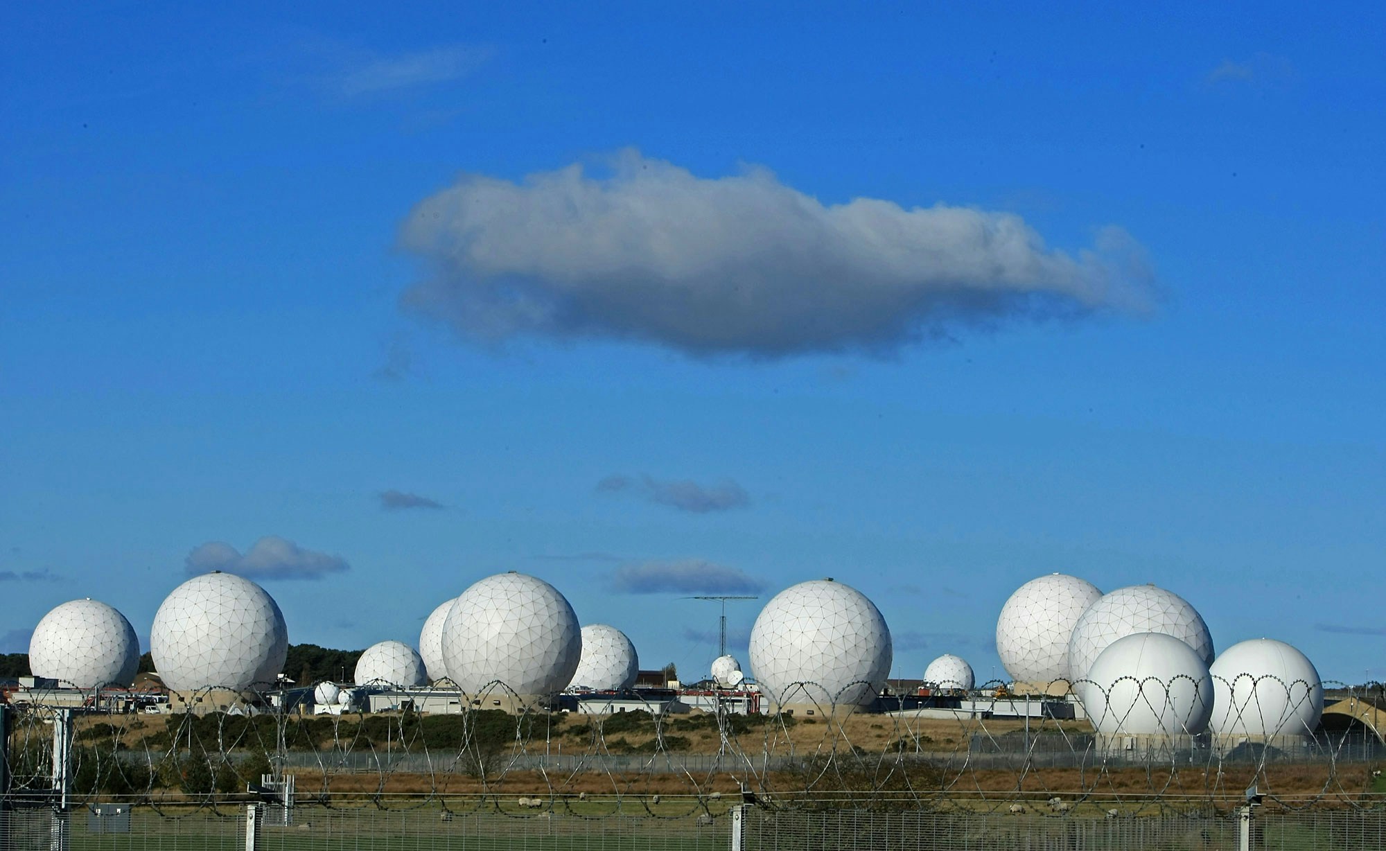 HARROGATE, UNITED KINGDOM - OCTOBER 30:  The radar domes of RAF Menwith Hill in north Yorkshire dominate the skyline on 30 October, 2007, Harrogate, England. The base is reported to be the biggest spy base in the world. Britain recently agreed to a United States request for the RAF Menwith Hill monitoring station, also known as the 13th field station of the US national security agency, in North Yorkshire to be used as part of its missile defence system. Dubbed 'Star Wars Bases' by anti-war and CND campaigners. The facility houses British and United States personnel.  (Photo by Christopher Furlong/Getty Images)