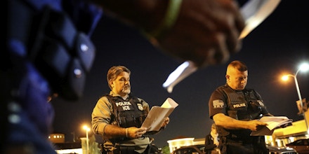 RIVERSIDE, CA - AUGUST 12: Jorge Field, left, and David Marin, both with ICE Enforcement and Removal Operations, getting briefed before getting out into the Riverside community to apprehend immigrants who may be deportable. Immigration and Customs Enforcement officials say they are relying more than ever on costly manhunts to locate immigrants in the country illegally who have criminal records. In the past, the agency would simply contact local jails where such immigrants were being detained and ask jail officials to hold them until an ICE van could pick them up, but hundreds of counties across the country stopped honoring such requests after a federal judge last year found that practice unconstitutional. (Irfan Khan/Los Angeles Times via Getty Images)
