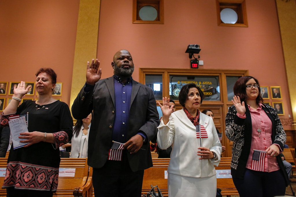 Candidates for US citizenship take the oath of allegiance during a Naturalization Ceremony for new US citizens at the City Hall of Jersey City in New Jersey  on February 22, 2017. / AFP / KENA BETANCUR        (Photo credit should read KENA BETANCUR/AFP/Getty Images)