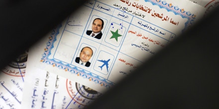 Ballots with photos and names of presidential candidates Abdel-Fattah el-Sissi, at top, and Moussa Mustafa Moussa, are visible inside a ballot box at a polling station, during the first day of the presidential election, in Cairo, Egypt, Monday, March 26, 2018. Egyptians head to the polls on Monday but the presidential election this time is not about who wins — that was settled long ago — but about how many people bother to cast ballots. (AP Photo/Amr Nabil)