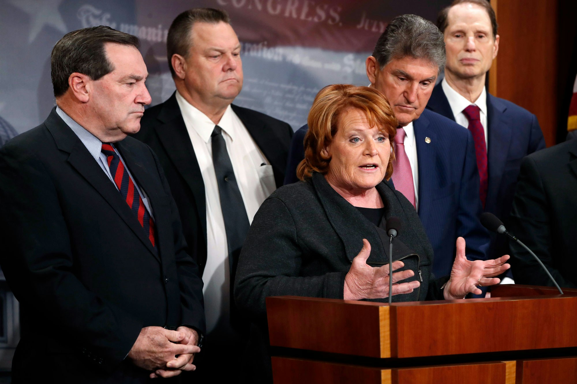 Sen. Heidi Heitkamp, D-N.D., speaks, as she is accompanied by Sen. Joe Donnelly, D-Ind., left, Sen. Jon Tester, D-Mont., Sen. Joe Manchin, D-W.Va., and Sen. Ron Wyden, D-Ore., during a news conference about their hopes for a bipartisan approach to tax reform, Tuesday, Nov. 28, 2017, on Capitol Hill in Washington. (AP Photo/Jacquelyn Martin)