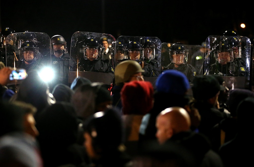 FERGUSON, MO - NOVEMBER 24:  St. Louis County police officers in riot gear stand guard in front of the Ferguson police department after a grand jury's decision was delivered on November 24, 2014 in Ferguson, Missouri. A St. Louis County grand jury has decided to not indict Ferguson police Officer Darren Wilson in the shooting of Michael Brown that sparked riots in Ferguson, Missouri in August.  (Photo by Justin Sullivan/Getty Images)
