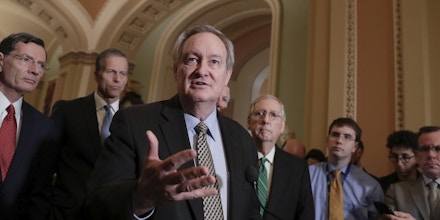 Sen. Mike Crapo, R-Idaho, chairman of the Senate Banking Committee, joined by, from left, Sen. John Barrasso, R-Wyo., Sen. John Thune, R-S.D., and Senate Majority Leader Mitch McConnell, R-Ky., right, talks to reporters as the Senate moves closer to passing legislation to roll back some of the safeguards Congress put in place to prevent a repeat of the 2008 financial crisis, during a news conference at the Capitol in Washington, Tuesday, March 6, 2018. (AP Photo/J. Scott Applewhite)