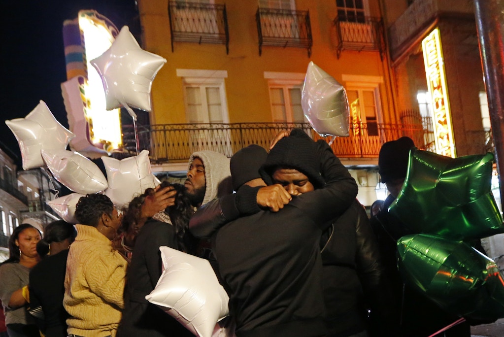People gather for a vigil at Bourbon Street and Iberville Street for Demontris Toliver, who was killed in a shooting in the early morning, in the French Quarter section of New Orleans, Sunday, Nov. 27, 2016. Police had already increased patrols in New Orleans' bustling French Quarter before gunfire erupted early Sunday, leaving at least one man dead and several other people wounded in the tourist district known for its bars, bright lights and live music. (AP Photo/Gerald Herbert)
