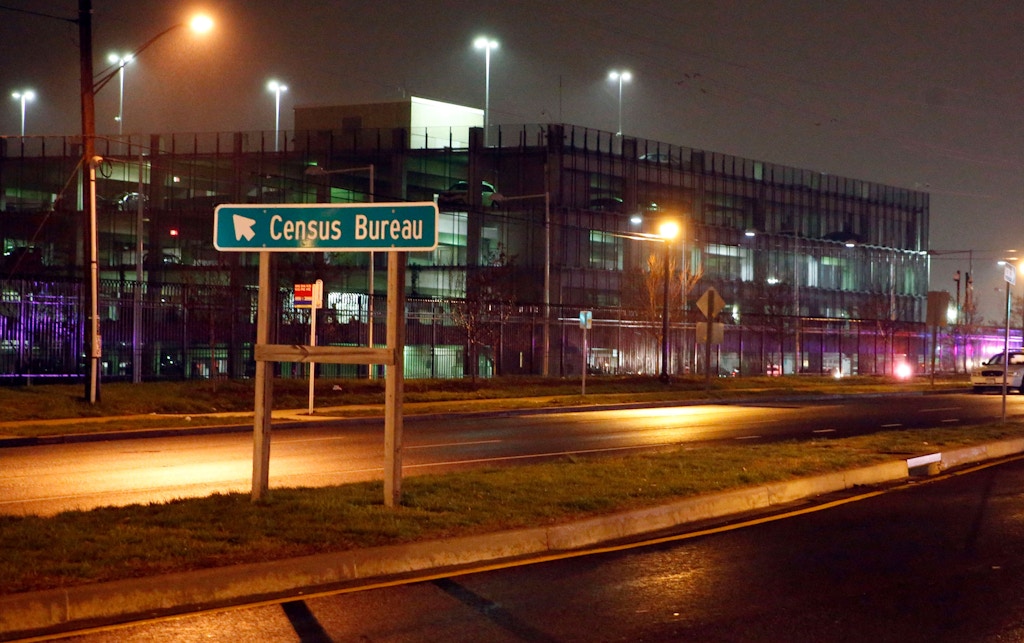 A sign for the U.S. Census  Bureau headquarters campus as police search for an armed man who, according to a fire official, shot a security guard at a gate to the facility in Suitland, Md., Thursday, April 9, 2015. (AP Photo/Alex Brandon)