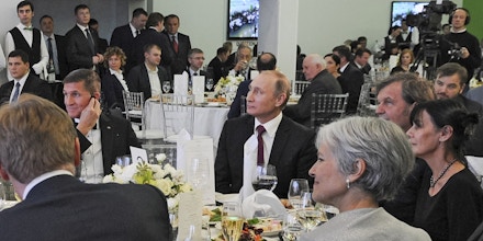 FILE- In this file photo taken on Thursday, Dec. 10, 2015, Russian President Vladimir Putin, center right, with retired U.S. Lt. Gen. Michael T. Flynn, center left, and Serbian filmmaker Emir Kusturica, obscured second right, attend an exhibition marking the 10th anniversary of RT (Russia Today) 24-hour English-language TV news channel in Moscow, Russia. Flynn is widely reported Thursday Nov. 17, 2016, to be a potential contender to become national security advisor to U.S. president elect Donald Trump, although his appointment may be controversial. (Mikhail Klimentyev/Sputnik, Kremlin Pool Photo via AP, file)