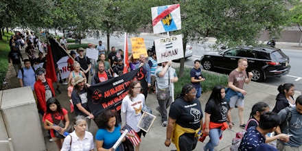 Protesters march during a rally in support of undocumented immigrants in Charlotte, N.C., Monday, May 1, 2017. (AP Photo/Chuck Burton)