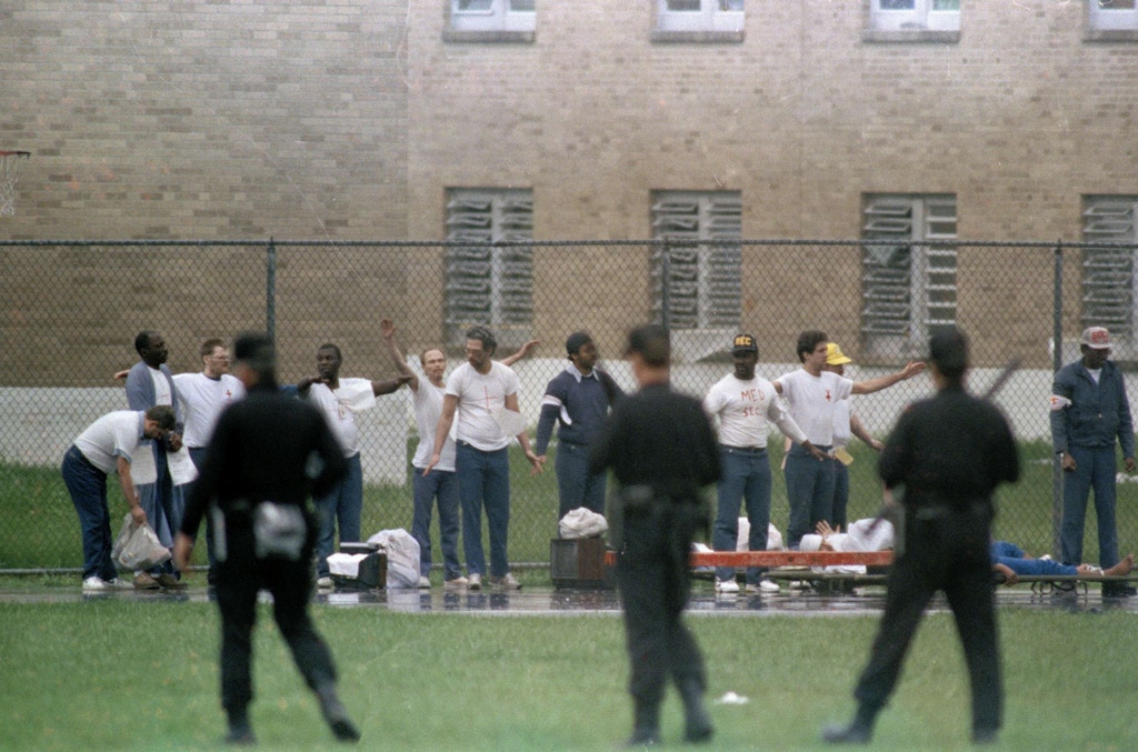 FILE - This April 21, 1993 file photo shows inmates raising their hands in surrender as armed guards watch on the recreation yard of the Southern Ohio Correctional Facility in Lucasville, Ohio. In the 20 years since the nation's longest deadly prison riot broke out in Lucasville, no interviews have been granted with the five men sentenced to death in the killing of a guard. Yet time has brought new evidence and insights that will dominate events marking the 20th anniversary of the 11-day siege of April 1993. (AP Photo/Lennox McLendon, File)