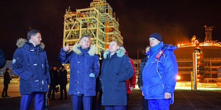 Russian President Vladimir Putin (C), accompanied by Novatek chief Leonid Mikhelson (2nd L) and Russia's energy minister Alexander Novak (L), visits under construction facilities of the Yamal LNG plant in the port of Sabetta on the Yamal peninsula beyond the Arctic circle on December 8, 2017.Vladimir Putin on December 8, 2017 launched a $27 billion liquefied natural gas plant in the Siberian Arctic as Russia hopes to surpass Qatar to become the world's biggest exporter of the chilled fuel. / AFP PHOTO / SPUTNIK / Alexey DRUZHININ (Photo credit should read ALEXEY DRUZHININ/AFP/Getty Images)