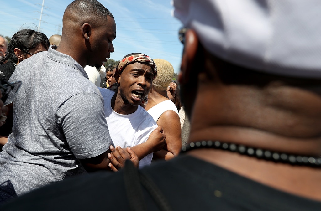 SACRAMENTO, CA - MARCH 29:  Stevante Clark, whose brother Stephon was shot and killed by Sacramento police, reacts as he meets with mourners outside of the funeral services for Stephon at the Bayside Boss Church on March 29, 2018 in Sacramento, California. Funeral services were held for Stephon Clark who was shot and killed by Sacramento police who thought he was carrying a gun over a week ago. Clark was found to only have a cell phone.  (Photo by Justin Sullivan/Getty Images)