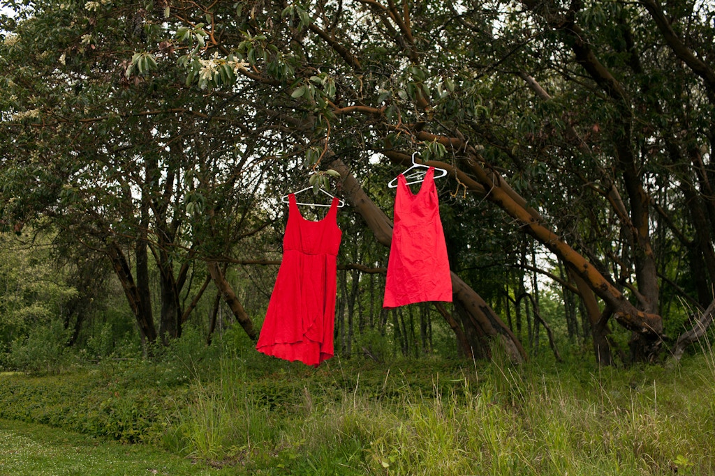 Two red dresses hang in a tree at Swan Creek Park on Friday, May 11, 2018, in Tacoma, Wash. The red dresses symbolize murdered and missing indigenous women. Carolyn DeFord’s mother, Leona LeClair Kinsey, a member of the Puyallup Tribe, disappeared 18 years ago. As time went on after her mother’s disappearance, DeFord began reaching out to other women whose family members had gone missing. She started a Facebook page with their faces and the details of their cases. (Jovelle Tamayo for The Intercept)