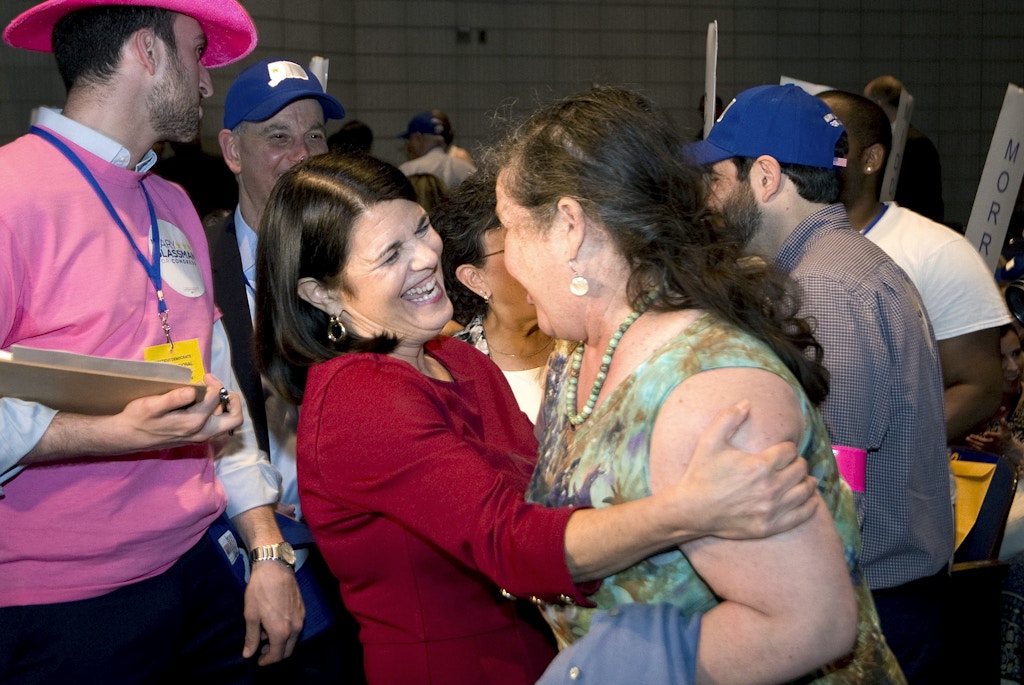 Candidate Mary Glassman, center left, is greeted by a supporter during the Democratic convention for the 5th District, Monday, May 14, 2018, at Crosby High School in Waterbury, Conn. (Jim Shannon/Republican-American via AP)