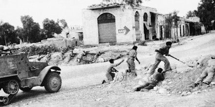 A detachment of Israeli soldiers with motorized support presses on during a recent attack on a small village somewhere in the Negev area of Palestine, Jan. 6, 1949. Resumption of fighting late in December resulted in a cease-fire order by the U.N. Security Council. An Israeli foreign office spokesman said Israeli troops have withdrawn after piercing 30 miles into Egypt and inflicting heavy casualties on Egyptian forces in three days fighting. (AP Photo)