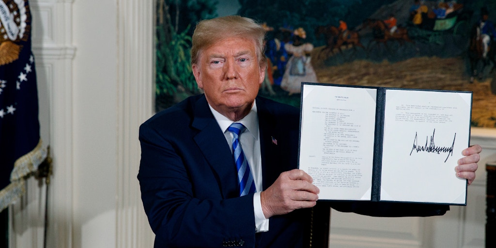 President Donald Trump shows a signed Presidential Memorandum after delivering a statement on the Iran nuclear deal from the Diplomatic Reception Room of the White House, Tuesday, May 8, 2018, in Washington. (AP Photo/Evan Vucci)
