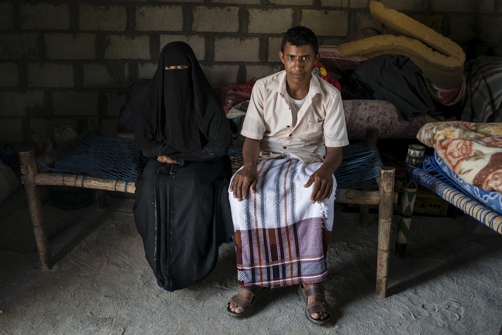 Yahya Ja'afar, 20, sits with his wife Fatum Alam, 20, on May 6, 2018 in al Ragha Village, Bani Qais District, Hajjah, Yemen. Their wedding celebration turned into a nightmare when an airstrike hit the mens side of the celebrations. They only officially moved in together and married two weeks after the destroyed wedding.