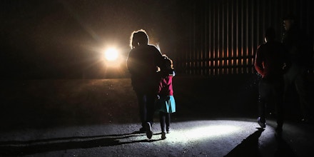 PENITAS, TX - FEBRUARY 22:  A Honduran mother walks with her children next to the U.S.-Mexico border fence as they turned themselves in to Border Patrol agents on February 22, 2018 near Penitas, Texas. Thousands of Central American families continue to enter the U.S., most seeking political asylum from violence in their home countries. The Rio Grande Valley has the highest number of undocumented immigrant crossings and narcotics smuggling of the entire U.S.-Mexico border.  (Photo by John Moore/Getty Images)