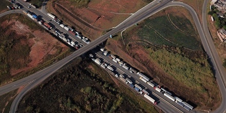 Aerial view of Brazilian truck drivers blocking the BR-262 highway with their trucks, during the fifth day of strike to protest against the diesel fuel price-rise, in Juatuba, Minas Gerais state, Brazil, May 25, 2018. - Brazilian President Michel Temer ordered security forces Friday to clear road blockades set up by truckers who pressed on with a strike that has left the vast country virtually paralyzed. (Photo by DOUGLAS MAGNO / AFP)        (Photo credit should read DOUGLAS MAGNO/AFP/Getty Images)