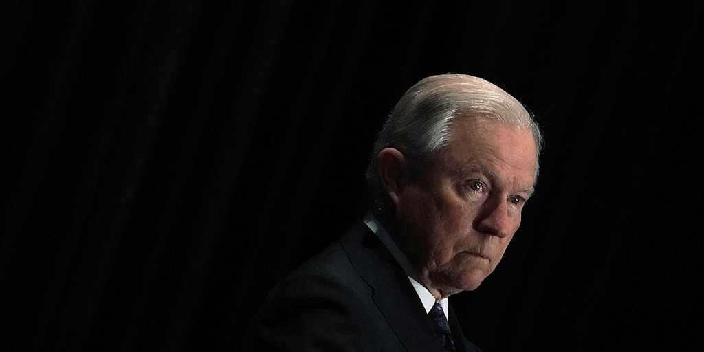 TYSONS, VA - JUNE 11:  U.S. Attorney General Jeff Sessions listens as he is introduced during the Justice Department's Executive Officer for Immigration Review (EOIR) Annual Legal Training Program June 11, 2018 at the Sheraton Tysons Hotel in Tysons, Virginia. Sessions spoke on his intention to limit reasons for people to claim asylum in the U.S.  (Photo by Alex Wong/Getty Images)