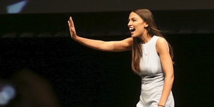 Alexandria Ocasio-Cortez, a Democratic congressional candidate from New York, waves during a rally, Friday, July 20, 2018, in Wichita, Kan. Ocasio-Cortez along with U.S. Sen. Bernie Sanders, Vt.-I, were at the rally to support Kansas congressional candidate James Thompson. (Jaime Green/The Wichita Eagle via AP)