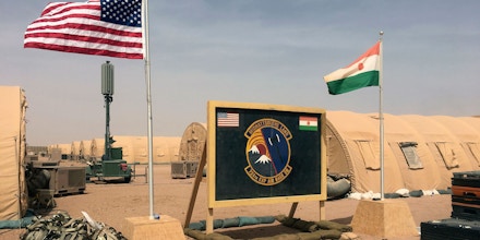 In this photo taken Monday, April 16, 2018, a U.S. and Niger flag are raised side by side at the base camp for air forces and other personnel supporting the construction of Niger Air Base 201 in Agadez, Niger. On the scorching edge of the Sahara Desert, the U.S. Air Force is building a base for armed drones, the newest front in America's battle against the growing extremist threat in Africa's vast Sahel region. Three hangars and the first layers of a runway command a sandy, barren field. Niger Air Base 201 is expected to be functional early next year. (AP Photo/Carley Petesch)