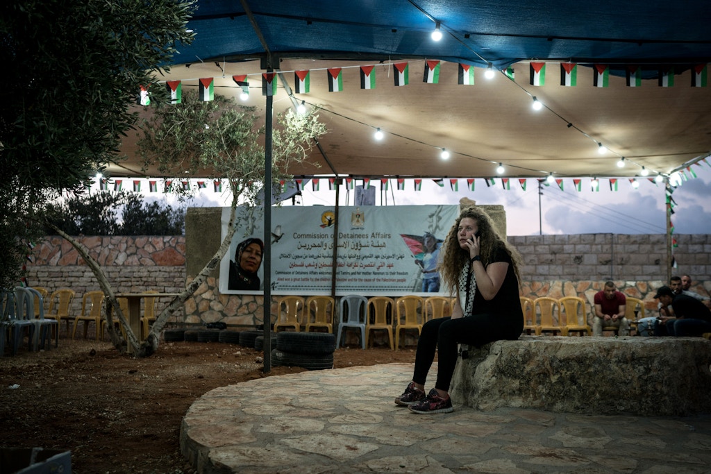 Ahed Tamimi speaks over the phone after journalsist and relatives left her house in Nabi Saleh on July 29, 2018 following the release of the Tamimi women.