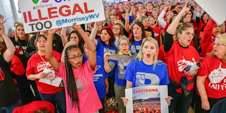 Teachers hold a rally outside the Senate Chambers in the West Virginia Capitol Monday, March. 5, 2018 in Charleston, W.V. Hundreds of teachers from 55 counties are on strike for pay raises and better health benefits,  (AP Photo/Tyler Evert)