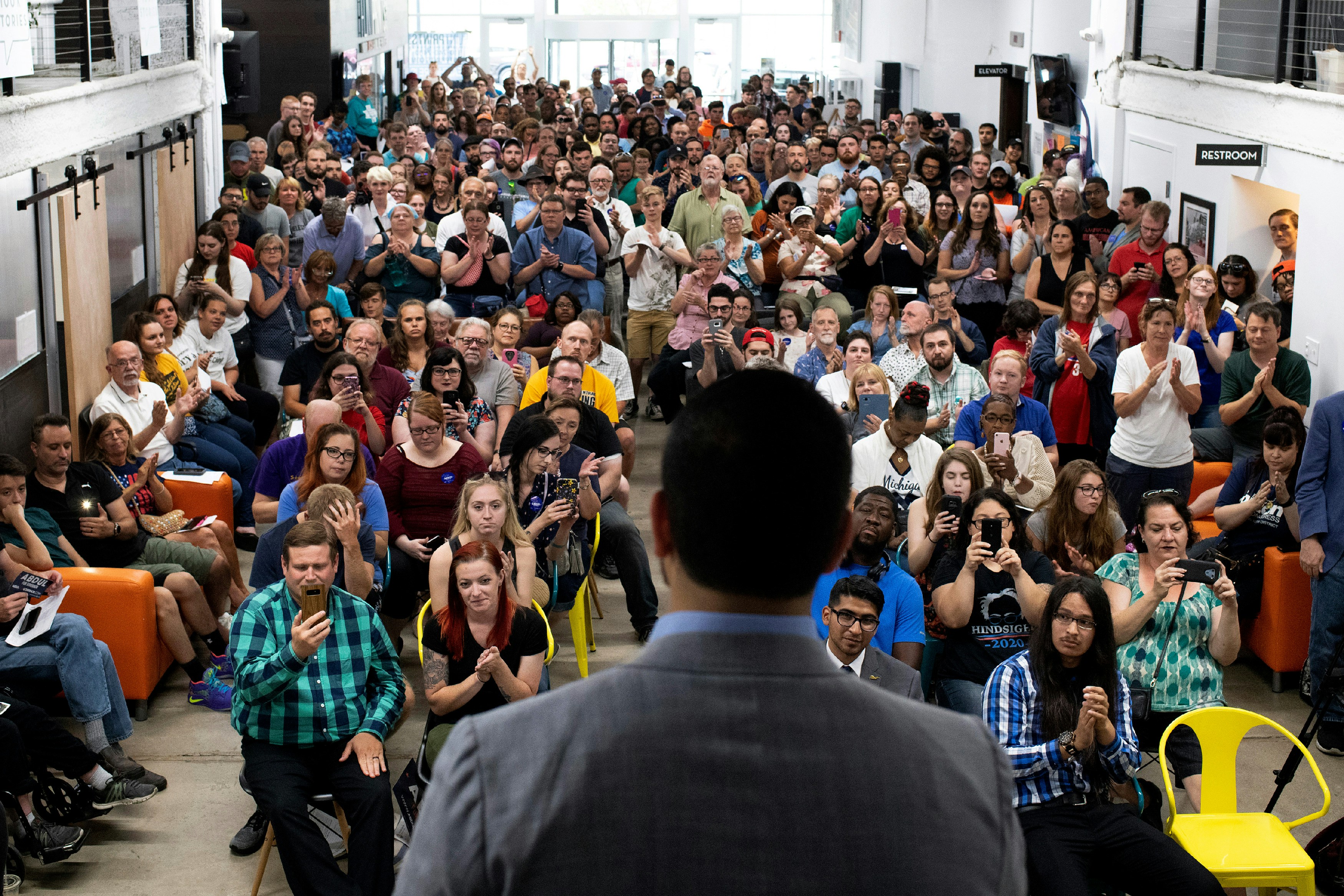 Michigan Democratic Gubernatorial candidate Abdul El-Sayed speaks to a crowd during his campaign rally with Alexandria Ocasio-Cortez at the Ferris Wheel building in Flint, Michigan on Saturday, July 28, 2018. (Rachel Woolf for The Intercept)