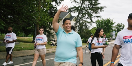 Kerri Evelyn Harris, Democratic candidate for the United States Senate from Delaware, waves while walking in a parade celebrating Delaware City Day in Delaware City, Delaware on Saturday, July 21, 2018. Harris, a former community organizer and Air Force veteran, is campaigning on issues such as Medicare-For-All, environmental justice, higher minimum wage, expanding LGBTQ rights, and pre-K for all.(Michelle Gustafson for The Intercept)