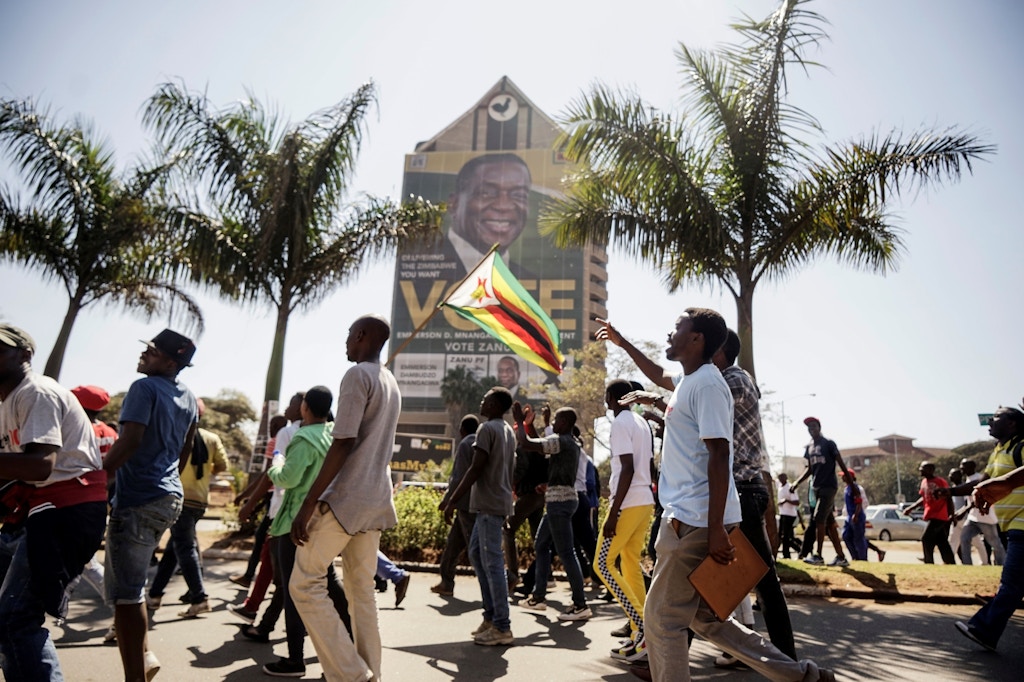 Opposition Movement for Democratic Change (MDC) supporters walk towards the Zimbabwe Electoral Commission (ZEC) headquarters on August 1, 2018 in Harare, to protest against alleged fraud in elections. - Zimbabwe's ruling ZANU-PF party won the most seats in parliament, official results showed on August 1, 2018, as the opposition MDC protested against alleged widespread fraud and the count continued in the key presidential race. (Photo by Zinyange AUNTONY / AFP)        (Photo credit should read ZINYANGE AUNTONY/AFP/Getty Images)
