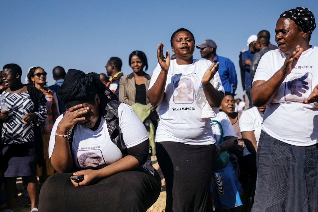 Relatives and friends mourn on August 4, 2018 at the end of the funeral gathering for Sylvia Maphosa, shot during the post election violence in Harare on August 1, the day after the nation went to the polls in national elections. - At least six people died after troops in the capital Harare opened fire on demonstrators on August 1, alleging that President Emmerson Mnangagwa had stolen the election from MDC leader Nelson Chamisa. (Photo by MARCO LONGARI / AFP)        (Photo credit should read MARCO LONGARI/AFP/Getty Images)