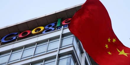 A Chinese flag flutters near the Google logo on top of Google's China headquarters in Beijing, China, Friday, Jan. 22, 2010. U.S. Secretary of State Hillary Rodham Clinton on Thursday urged China to investigate cyber intrusions that led search angle Google to threaten to pull out of that country, and challenged Beijing to openly publish its findings. (AP Photo/Ng Han Guan)