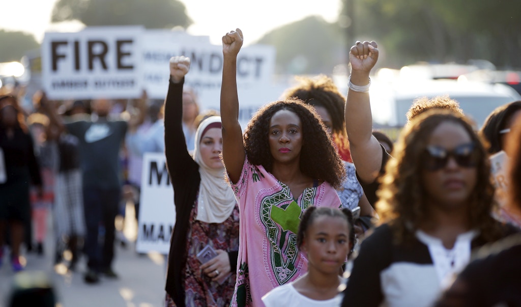 Demonstrators march around AT&T Stadium ahead of an NFL football game between the Dallas Cowboys and the New York Giants in protest of the recent killings of two black men by police, in Arlington, Texas, Sunday, Sept. 16, 2018. Botham Jean and O'Shae Terry were fatally shot by police in North Texas earlier in the month. (AP Photo/Brandon Wade)