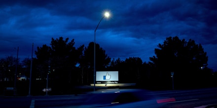 TOPSHOT - A car passes by Facebook's corporate headquarters location in Menlo Park, California, on March 21, 2018. Facebook chief Mark Zuckerberg vowed on March 21 to 