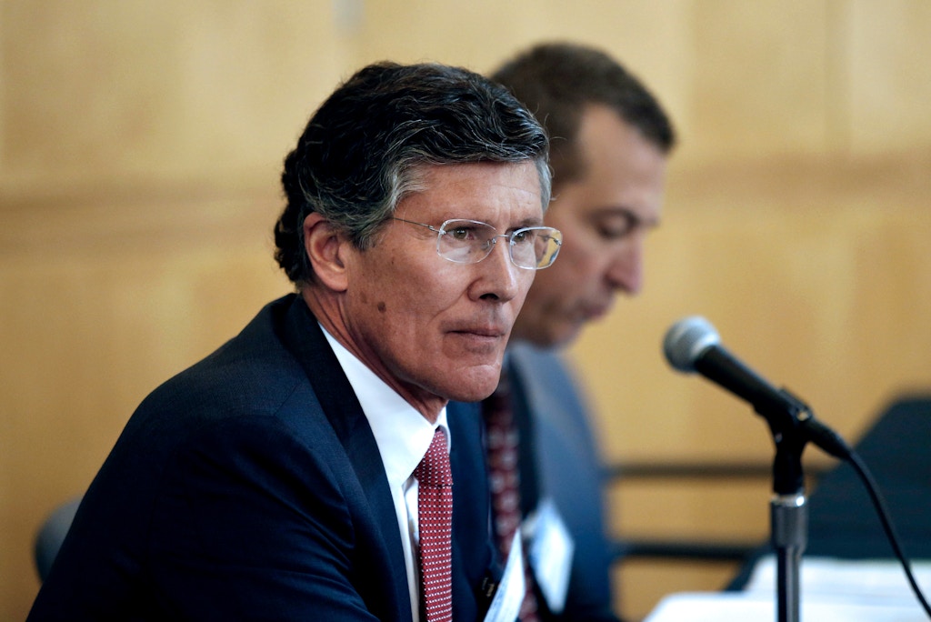 John Thain, chairman and chief executive officer of CIT Group, left, listens during a public meeting held by the Federal Reserve Board and the Office of the Comptroller of the Currency (OCC) in Los Angeles, California, U.S., on Thursday, Feb. 26, 2015. The intent of meeting is to collect information relating to the convenience and needs of the communities to be served by the merger of CIT Bank into OneWest Bank, including a review of the insured. Photographer: Patrick T. Fallon/Bloomberg via Getty Images