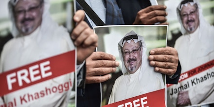 TOPSHOT - Protestors hold pictures of missing journalist Jamal Khashoggi during a demonstration in front of the Saudi Arabian consulate on October 8, 2018 in Istanbul. - Jamal Khashoggi, a veteran Saudi journalist who has been critical towards the Saudi government has gone missing after visiting the kingdom's consulate in Istanbul on October 2, 2018, the Washington Post reported. Turkey has sought permission to search Saudi Arabia's consulate in Istanbul after a prominent journalist from the kingdom went missing last week following a visit to the building, Turkish television reported on October 8. (Photo by OZAN KOSE / AFP)        (Photo credit should read OZAN KOSE/AFP/Getty Images)
