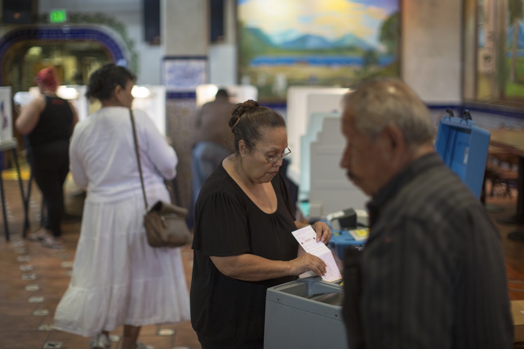 LOS ANGELES, CA - NOVEMBER 08: Latinos vote at a polling station in El Gallo Restaurant on November 8, 2016 in the Boyle Heights section of Los Angeles, California. In addition to choosing between Republican Donald Trump or Democrat Hillary Clinton for President of the United States, Californians are deciding on 17 ballot propositions.   (Photo by David McNew/Getty Images)
