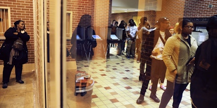 Voters wait in line on election day after an order issued in Fulton County Superior Court ordered the polling location to remain open until 10 p.m., a full three hours after polls closed statewide, in Atlanta, Tuesday, Nov. 6, 2018. A judge has extended voting hours at more polling locations in Georgia, where some voters have complained of waiting for hours in long lines. (AP Photo/David Goldman)