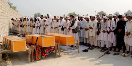 Afghan men offer funeral prayers near the bodies of civilians killed in a NATO air strike, on the outskirts of Jalalabad, east of Kabul, Afghanistan, Saturday, Oct. 5, 2013. An Afghan official says a NATO strike in the country's east has killed several civilians, but the U.S.-led coalition says that it targeted insurgents and that its initial reports indicate no civilian casualties. Afghan and NATO officials regularly differ as to whether civilians have been hit in attacks. Afghan President Hamid Karzai has made denunciations of reported civilian deaths in airstrikes a pillar of his political strategy. (AP Photo/Nisar Ahmad)