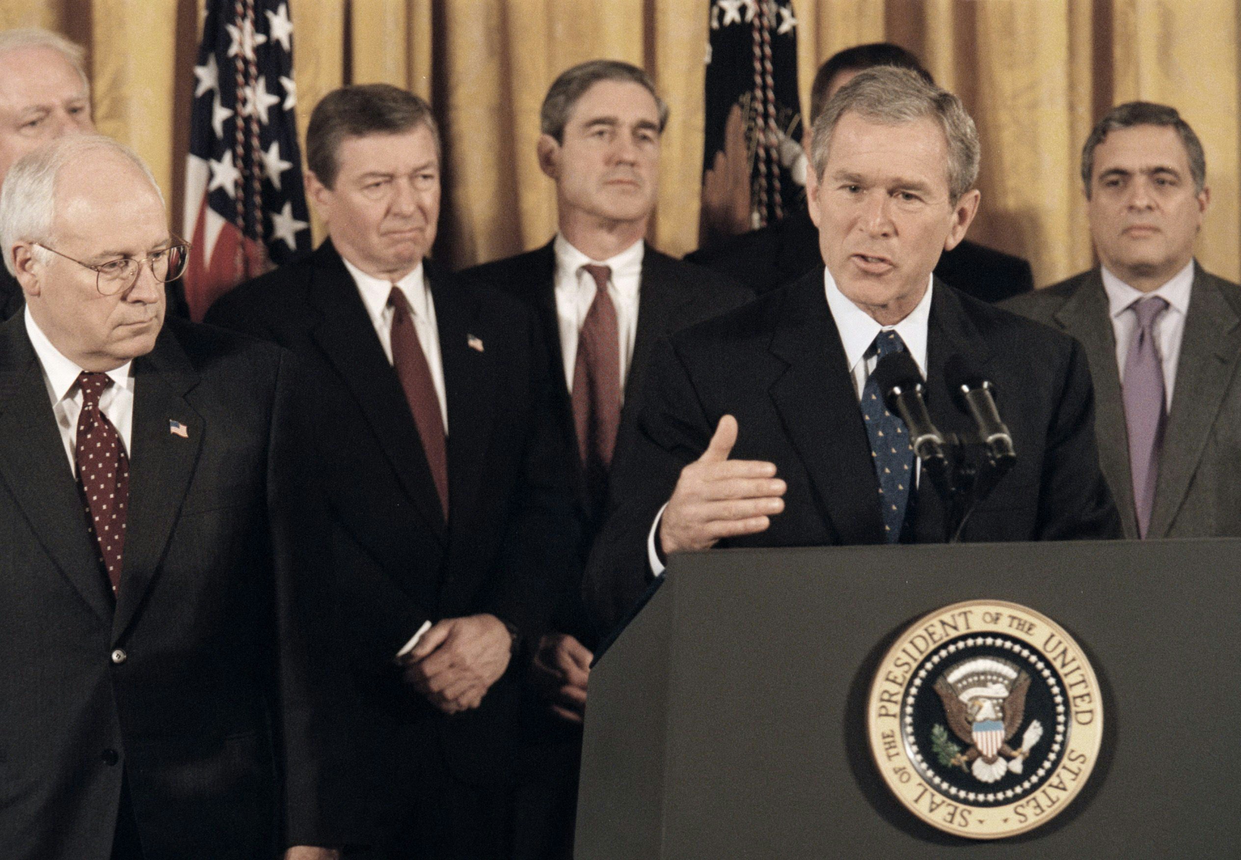 WASHINGTON, DC - OCTOBER 26 - President George Bush delivers speech before signing Patriot Act Anti-Terrorism Bill at the White House. Shown next to Bush,  Vice President Dick Cheney, shown in background (L-R) Rep. James Sensenbrenner, Attorney General John Ashcroft, FBI Director Robert Mueller and CIA Director George Tenet. (Photo by Rich Lipski/The Washington Post via Getty Images)