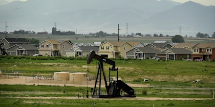 DACONO, CO - JUNE 7: An oil derrick pumps oil near a subdivision roundabout looking west on June 7, 2017 in Dacono, Colorado.  Gas and oil development, exploration and fracking operations are colliding more and more with subdivision and housing developments as the front range continues to grow. (Photo by Helen H. Richardson/The Denver Post via Getty Images)
