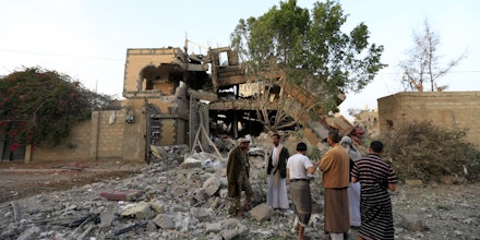 Yemenis inspect the damage as they stand in the rubble of a destroyed house in the aftermath of a reported air strike by the Saudi-led coalition in a neighbourhood in the Yemeni capital Sanaa on June 6, 2018. - According to media reports, at least nine Yemenis, including two women, were injured. (Photo by MOHAMMED HUWAIS / AFP)        (Photo credit should read MOHAMMED HUWAIS/AFP/Getty Images)